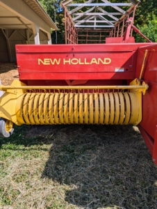 When the baler is in motion, the hay is picked up first in the front. Then it is formed into a bale.