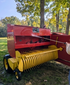 A baler is a piece of farm machinery used to compress a cut and raked crop into compact bales that are easy to handle, transport, and store.