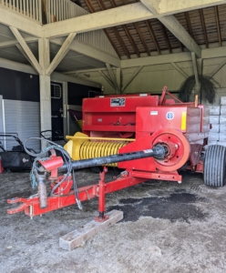 Here is the baler parked for the off-season. Chhiring checks the equipment periodically through the year to ensure it is all safe from moisture, mold, and pests. Good, clean, well-maintained equipment of any kind is sure to last many years.