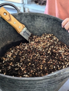 Ryan combines the elements together first. There are many pre-prepared bonsai soil mixes available, but mixing one's own can save money and allows control over the exact mixture for the tree species.