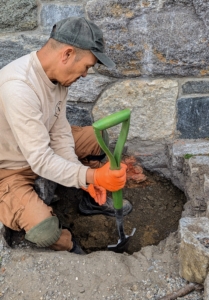 Underneath the pavers, Chhiring also removes other stones, stone dust, and gravel. The hole must be at least twice the size as the root ball. The sides are also sightly slanted.