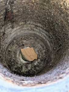 At the bottom of each container is a drainage hole. A clay shard is placed on top of the hole to help with drainage and to prevent soil from blocking the hole or from falling out.