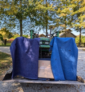 For really heavy potted specimens, we load them onto the bucket of a tractor that is lined with moving blankets, so the pots do not sustain any damage during transport.