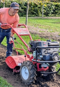 And then he starts tilling the bed with our Troy-Bilt Pony Rear-Tine Tiller. The machine is set to till the soil at about six to eight inches deep. On some tillers, the speed of the rotating tines helps determine the speed of the machine.