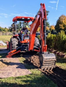 The crew works efficiently and quickly. Adan is very skilled with the backhoe, making it the precise depth for the boxwood, about a foot.