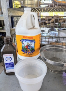 For the preparation process, Ryan gathers fish emulsion, isopropyl alcohol, a strainer and some plastic containers. Fish emulsion is an organic garden fertilizer that’s made from whole fish or parts of fish. It’s easy to find at garden centers or wherever gardening supplies and fertilizers are sold.