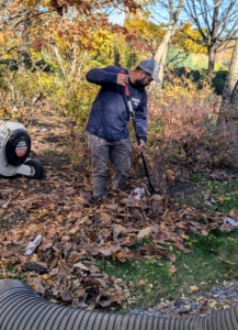 And here's Adan gathering the fallen leaves below my magnolia trees. Once the leaves are blown into a manageable pile, they are directed to the opening of a vacuum tube connected to our dump truck. The leaves are then taken to the compost area, where they will decompose and get used again as mulch.