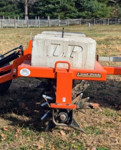 Weights are placed on top of the aerator attachment to ensure even aeration over the surface and to maximize penetration into the soil.