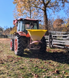 Here is the spreader, which is hitched to the back of the tractor. It moves the pulverized limestone and throws it about 30 feet out as it is driven through the field.