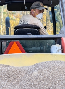 Chhiring goes slowly to ensure good coverage. He looks back often to check that the lime is running through the feeder correctly.