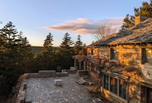 If you follow this blog regularly, you will recognize my large “cracked ice” terrace at Skylands. This photo taken from an upstairs terrace. Here, one can see the branches of the original kiwi vines on the house that are still thriving after all these years. The sundial above the doorway on the right is also original to the home. A sundial tells the time of day using the position of the sun in the sky. It has a flat plate and a gnomon, which casts a shadow onto the dial. It is very accurate.