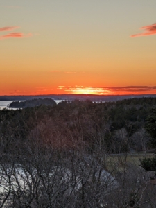 At sunset, the brilliant colors are reflected in the clouds - stunning red and orange hues.