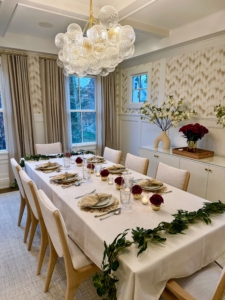 Chloe Zale is our Marquee Brands Culinary Director. She set this beautiful holiday table. Chloe melded old and new traditions by showcasing her grandmother’s china in her cozy tablescape at her new home in Westport, Connecticut. Burgundy mums added a touch of festivity to the bud vases at the center of the table and the vase on the buffet.