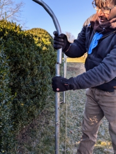 Each end of the bow piece is inserted into the tall ground pipes.