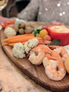 This board included fresh vegetables and shrimp.