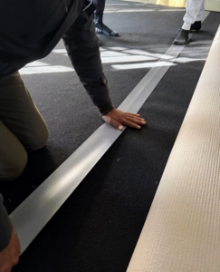 Because this room is large, two pieces of new padding are needed to secure the carpet. This padding is very durable and long lasting. Tape is used to connect the two pieces together, but don’t worry, the tape never touches the floor.