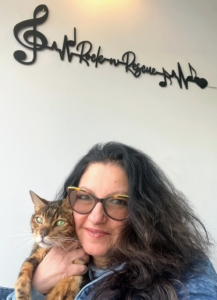 This is Juli Cialone, founder and executive director of Rock ’N Rescue. She is holding Kit, one of the center's two office cats.