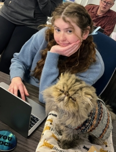 And this is foster coordinator, Kathleen Birmingham, with Scooter, her cat and the facility's therapy office feline.