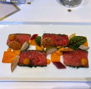 Another appetizer is this Thon et Kaki, a citrus cured yellowfin tuna with persimmon, rainbow Swiss chard, and bottarga, which is a salted, cured fish roe that's a delicacy in the Mediterranean and Asia.