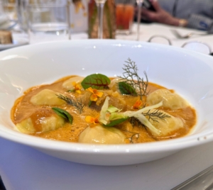 This is Ravioli de Homard - lobster raviolis, fennel confit, preserved lemon, in a bisque emulsion.