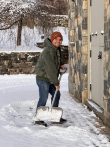 At 7am, my outdoor grounds crew is already busy clearing. Here's Jimmy shoveling snow from the doorways around my stable.