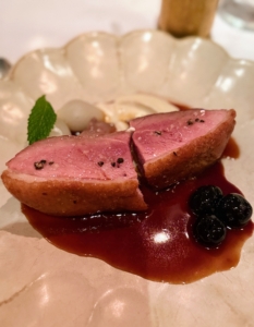 This entrée is called Filet de Canard aux Cerises - duck with almond pearl onions and cherry sauce - a very popular dish.