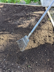 Ryan uses a small soft rake to freshen up the top layer of soil. All the beds were fed, so they’re ready to plant. I use a fertilizer specially formulated for growing vegetables – Miracle-Gro® Shake ‘n Feed® Tomato, Fruit & Vegetable Plant Food.