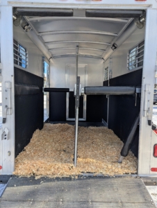 This is the inside of my horse trailer - it is all set with a fresh bed of shavings and the proper safety padding and bars.