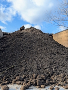 This compost is well decayed. The rich, dark, and crumbly compost can now support proper soil structure, improve water retention, and promote beneficial microbial life back in the gardens.