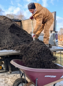 Here, Phurba fills a wheelbarrow with compost. I am so proud that I can make this material right here.