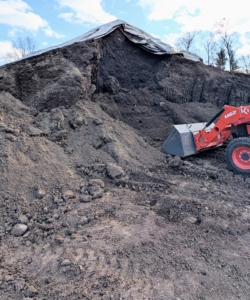 After it is all run through the tub grinder multiple times, it is left to decay naturally under giant tarps and made into garden compost - filled with nutrients.