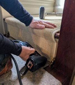 Dave works his way down the staircase, nailing the carpet as he goes.