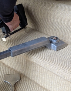 A carpet knee kicker is used to stretch the carpet. The tool grips the carpet with a set of tines on the head and then pushes it into place.