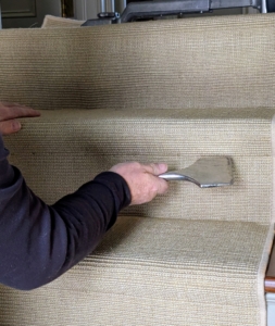 This is a carpet installation chisel - a tool with a wide, flat blade used to tuck the carpet into tight spaces and secure it against the surface and in corners.