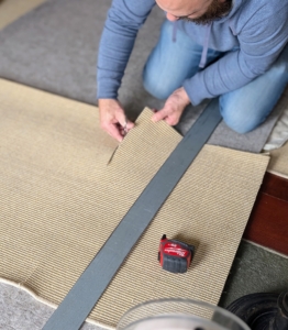 Here, the sisal is being cut to size, so spaces can be measured precisely. For most of the rooms, I use the same sisal. I like its durability, natural color, and coarse, slightly scratchy feel. Sisal comes from the long green leaves of the cactus plant Agave sisalana and is stronger than other natural fibers.