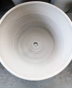 Each pot has a large drainage hole at the bottom.