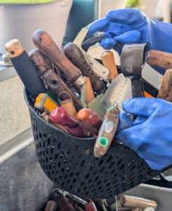 Here, Ryan places clean tools in a colander trug for drainage.