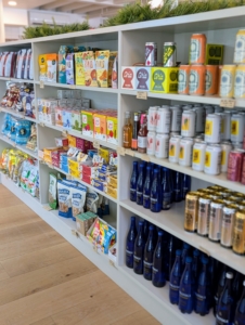 Several aisles of pantry items and grab-and-go snacks fill the shelves.