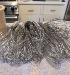 These are whisks. I have all kinds of whisks - big, small, classic, balloon, and flat whisks. Each kind is designed for a different function, but all are generally used for blending, beating, and whipping ingredients together.