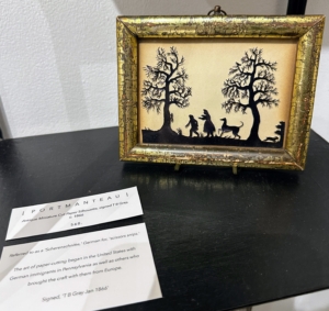 Other works were by little known craftsmen. This antique miniature cut-paper silhouette is signed by TB Gray, circa 1866. This fine work was presented by Portmanteau Antiques. Paper cutting art was referred to as a "scherenschbitte," which is German for 'scissor snips.' The practice began in the United States with German immigrants in Pennsylvania.