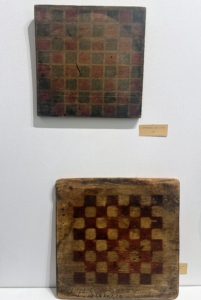 On the wall, Evan displayed handmade, and well-used game boards.