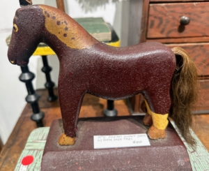 This is a 19th century folk art wooden horse toy made with a real horse hair tail.