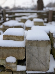 This is my snow-covered stone yard, a place where extra inventory of the many types of stones used at the farm are kept - slate shingles, marble flooring, granite posts, etc.