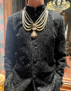 Here he is wearing the jacket and an elaborate necklace. In India, a formal man's necklace is traditionally worn by royalty and grooms.