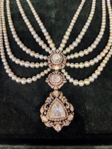 Here is a closeup of the piece decorated with diamonds and pearls. Men's jewelry reflects the country's rich culture and historical heritage.