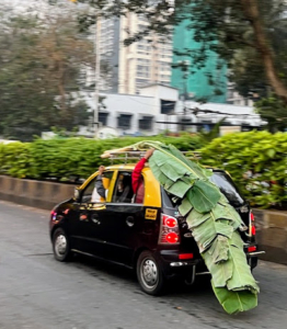 Kevin captured this car as it pulled out of the market with the day's purchase on the roof and supported by the passengers inside - where there is a will, there is a way.