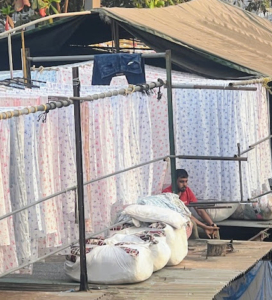 The washers, known as dhobis, work in the open air to clean the many linens and clothes from Mumbai's hotels, hospitals, and other large companies. Rows and rows of drying linens surround wash pens throughout the Dhobi Ghat.