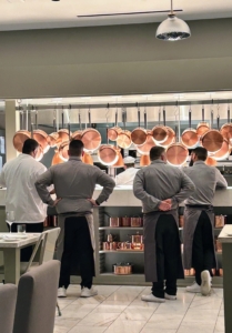 The service is impeccable. The wait staff gathers at the large counter waiting to bring out various dishes. Above are the hanging copper pans in a variety of sizes from my MARTHA by Martha Stewart collection. And yes, I also hang pots in my own kitchen.