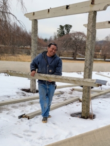 As each piece is taken down, it is placed in a pile at one end of the pergola.