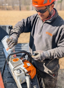 Here's Pasang, my resident tree expert, tending to his chainsaw in between cutting trees. Lubricating the chain and bar cools the engine while flushing out saw dust and other debris. Maintaining the equipment properly is paramount.